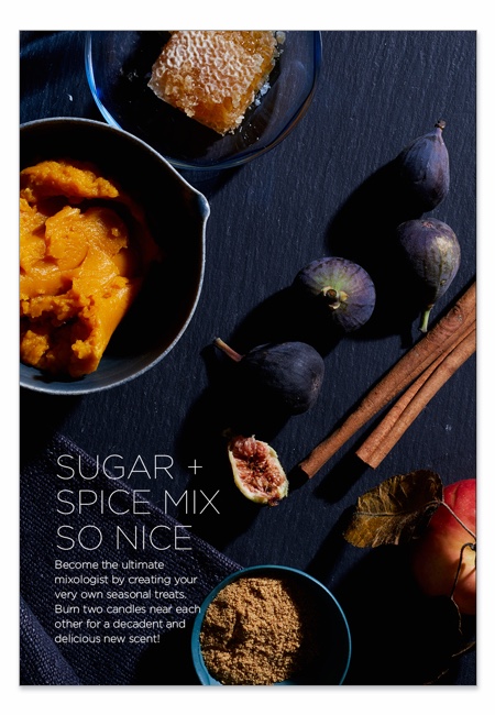 Baking ingredients on a dark blue background. Included are sugar, cinnamon,an apple, figs,and pumpkin