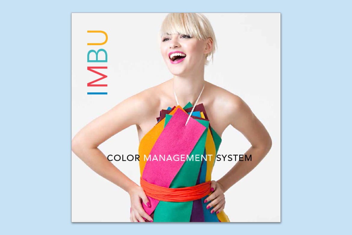 Woman smiling wearing a colorful dress made from several felt fabric swatches